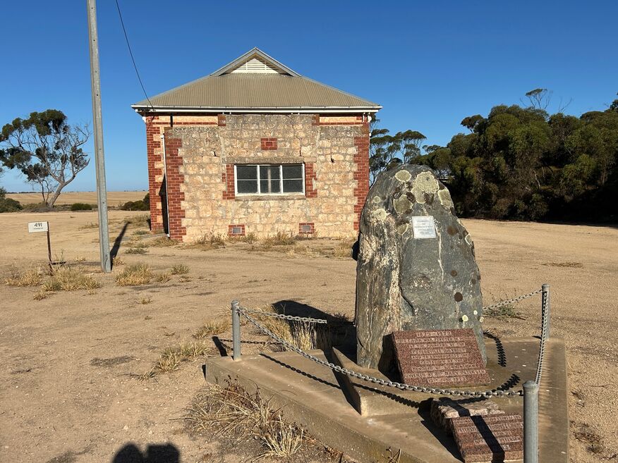 The Building is the Petersville Town Hall - A Stone marker in Foreground